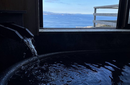 Shimotaga Haus | A spectacular view! Relax on the sea-view terrace / Scandinavian log house with hot spring & fireplace