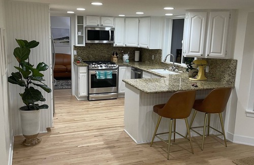 River Bottoms Haus | Beachy Home in Provo. Large deck with builtin hot tub, Fire pit, Palapa