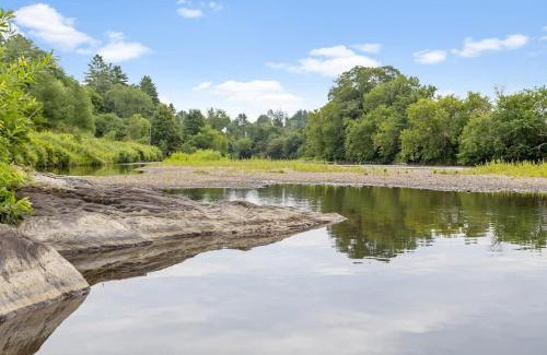 Johnson Haus | Caboose Tiny Home on river with hot tub near Stowe