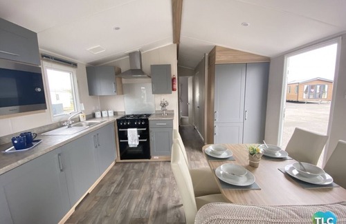 Dunbar Haus | Cosy 2 bedroom caravan with Patio doors onto decking, situated near Dunbar.