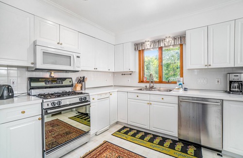 Arcadia Haus | Dog-friendly, lake view home with three season room, fireplace, video projector