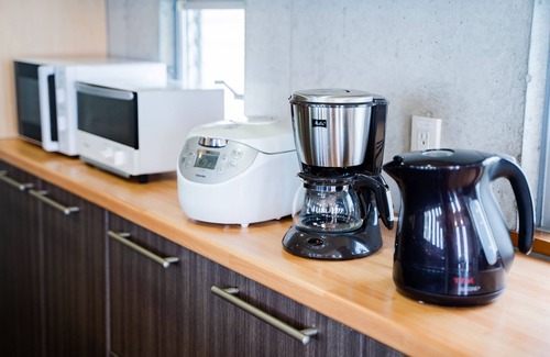 Kadena-cho Haus | EM tree house surrounding a healing tree