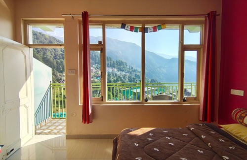 Dharamshala Bed & Breakfast | Golden View BnB Mcleodganj Room with private balcony facing mountain view.