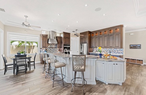 Cocoa Isles Country Club Haus | Gorgeous Direct Riverfront Pool Home W/ Private Balcony, Movie Room, & Fire Pit!