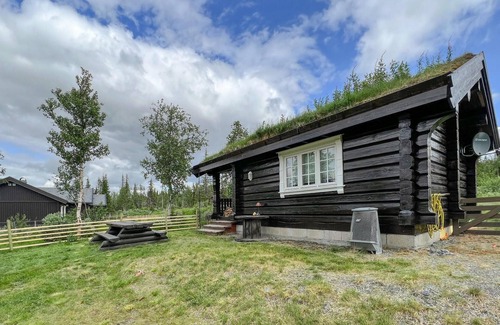Nord-Torpa Haus | Make yourself comfortable in this open-plan log cabin with a wonderful view of the countryside.