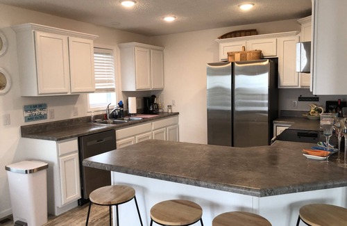 Oak Harbor Haus | New! 30 seconds from couch to shore, covered front porch w/sunset water views.