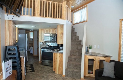 Meeker Haus | Our largest "not so tiny" tiny home, White River Casita is a beautiful modern tiny home that features a Queen bed on main level, one Queen bed in loft accessible by stairs, one Queen fold out couch with additional sleeping space in loft for sleeping