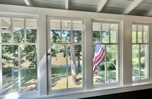 Everett Hütte | Riverfront Cottage offering a large enclosed porch overlooking the River!