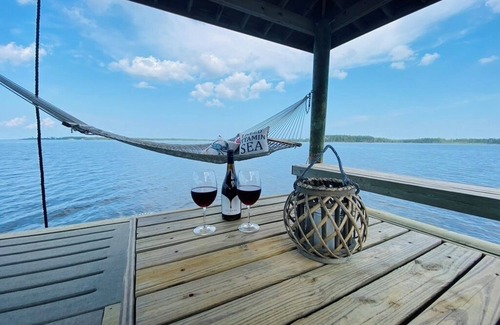 Hobucken Haus | Riverfront property with dock and ramp. Dolphins, fish, boat, swim & more