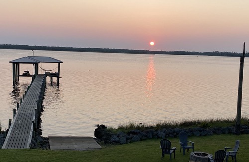 Hobucken Haus | Riverfront property with dock and ramp. Dolphins, fish, boat, swim & more