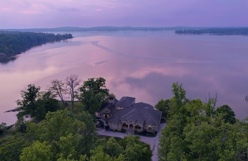 Earlville Villa | Stunning waterfront villa with indoor pool and kids swing set and play area.