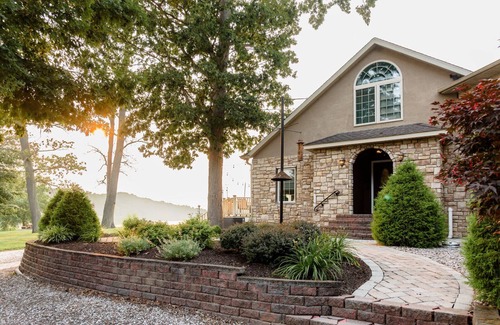 Earlville Villa | Stunning waterfront villa with indoor pool and kids swing set and play area.