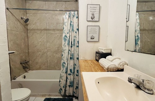 Nassau Haus | The Dollie Mae: Comfortable King Bed Suite