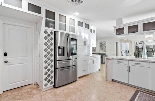 Sunset Haus | Villa Les Palmieres, a lush waterfront residence with pool and dock