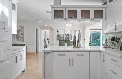 Sunset Haus | Villa Les Palmieres, a lush waterfront residence with pool and dock