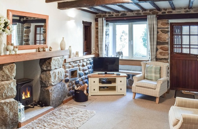 Adore the allure of this delightful cottage, featuring exposed beams and stonework.
