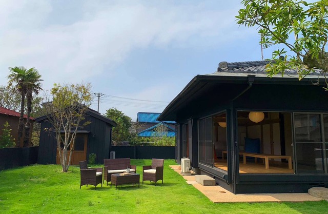 A house with a large garden and a detached house.