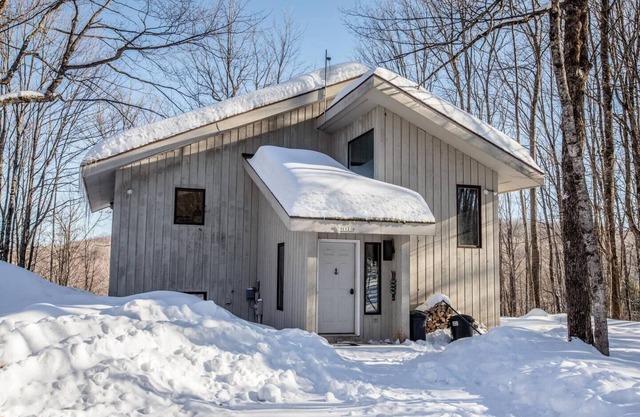 A Spacious Vacation Home in a Wooded Setting With A Brick Fireplace