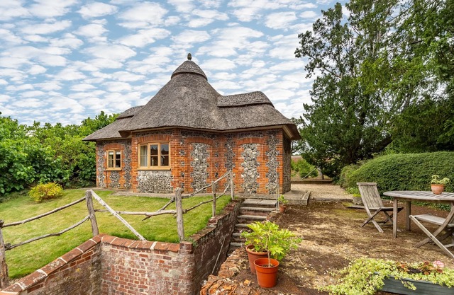 A unique octagonal brick and flint thatched Victorian cottage nestling in a tranquil village locatio