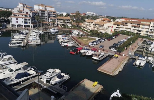 Air-conditioned seafront apartment with marina and mountain views
