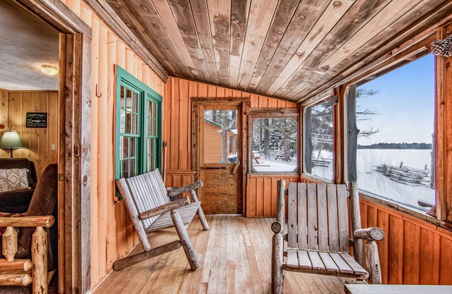 All-season lakefront cabin at Scott’s Twin Lake Resort with sunroom, beach, dock