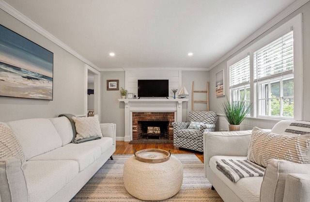 An elevated Cape Cod escape close to coveted beaches with fully fenced yard, new deck and firepit