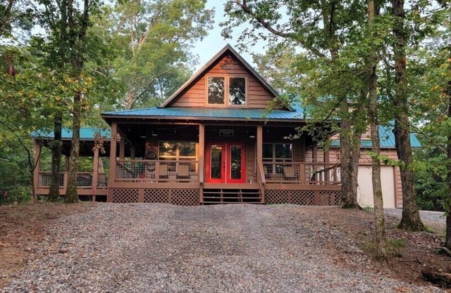 Cabin that is settled on top of a hill on ten acres