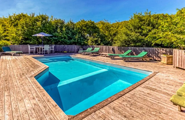 Beautiful ocean-view home near beach with private heated pool, fireplace, & deck