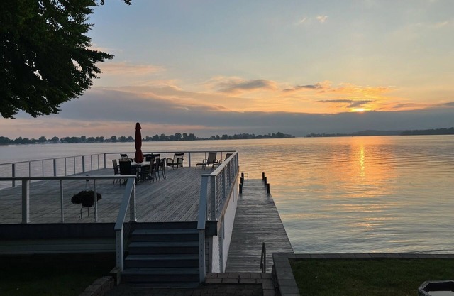 Beautifully updated home on the bay and golf course with dock and raised deck!