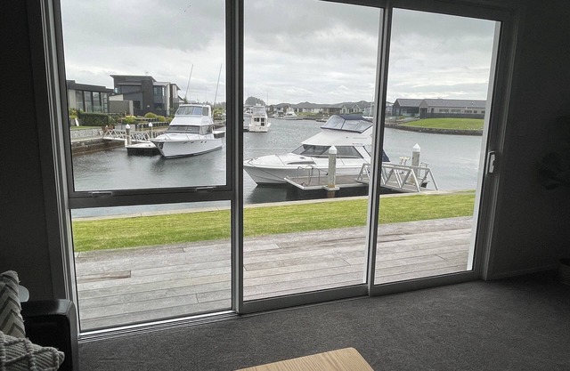 Brand new canal-front holiday home, stunning water views, private boat ramp.