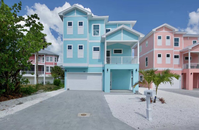 Brand new custom home STEPS from the beach and times square - Unbelievable bay views, stunning pool and spa and large entertaining space!