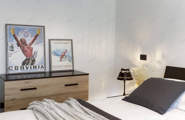 Bright apartment in the town center with ski storage and communal parking.