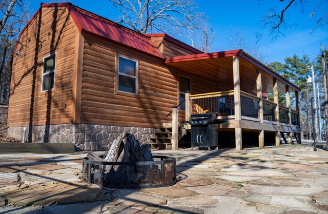 Cabin featuring a vaulted ceiling, a large porch, and huge patio with fire pit.