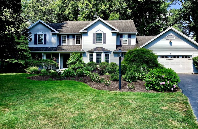 Charming, comfortable and spacious Pittsford home on a pond.
