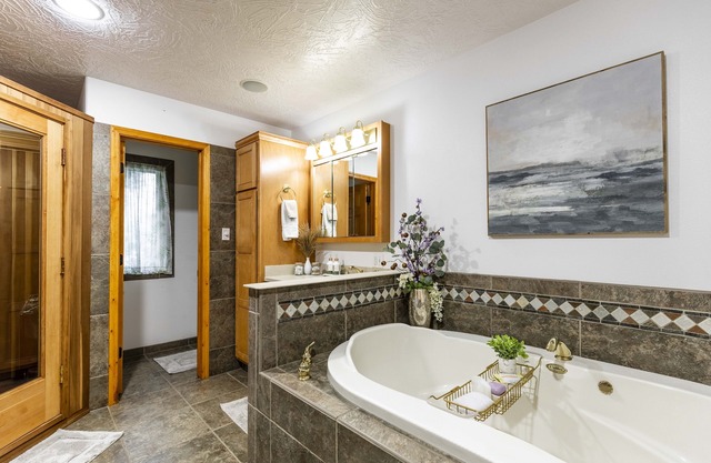 Charming house with sauna, jetted tub, and pool table. Cozy open floor plan.