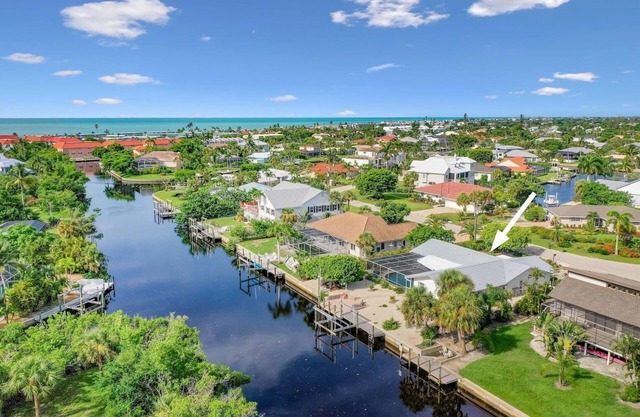 Coastal Charm: Stunning Ground Level Pool Home on Canal with EastEnd Location