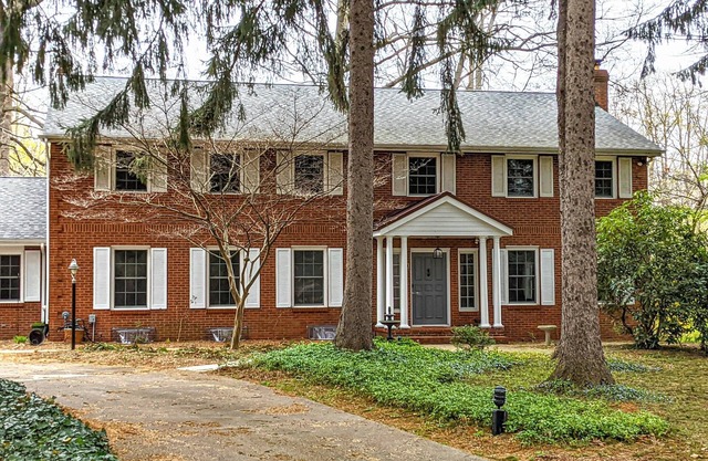 Colonial style 5BR/5BA home tucked in a private, wooded setting w/pool & hot tub