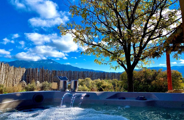 Colorful dog-friendly home with sweeping views, a private hot tub, & large yard