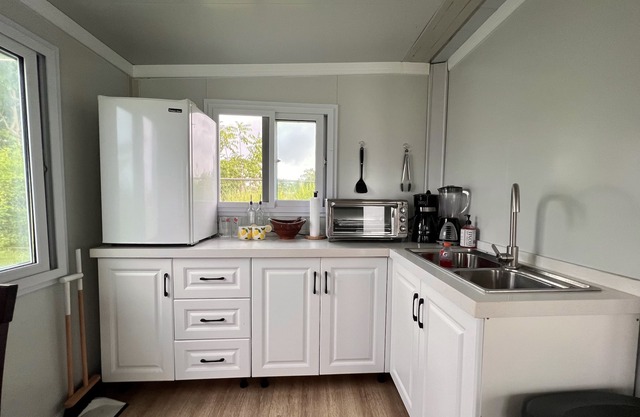Comfy and cozy mini house sitting on a beautiful 1500 meter lot. Great location!