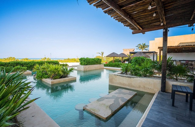 Contemporary beachfront apartment with pool, gym, ocean views, and balcony space