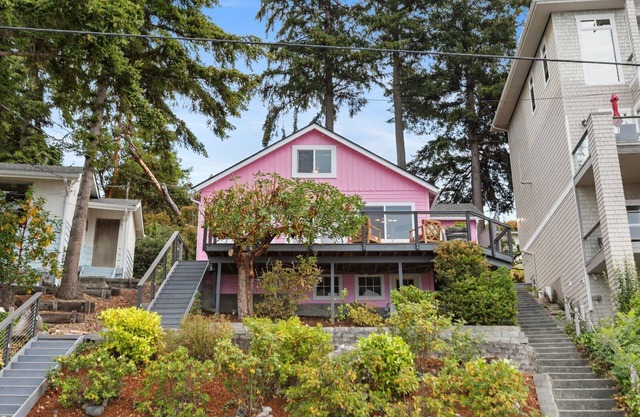 Darling pink beach house with epic views in a cozy community.