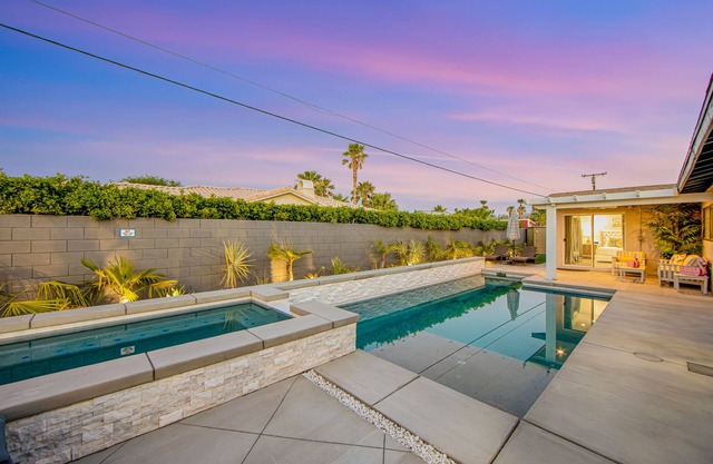 Designer dream with fireplace, game room, private pool, outdoor kitchen, firepit