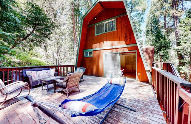 Dog-friendly 2-story home with large deck, tree views, fireplace, hammock, & W/D