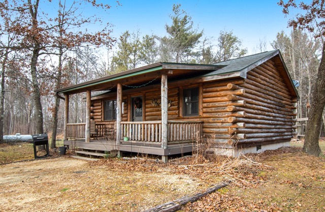 Dog-friendly cabin with gas fireplace, firepit, porch, & shared pond access