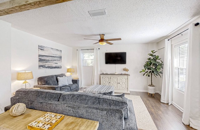 Dog-friendly home with fenced yard, patio, grill, & park across the street