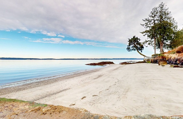 Dog-friendly water view home with private beach, firepit, kayaks, deck, & grill