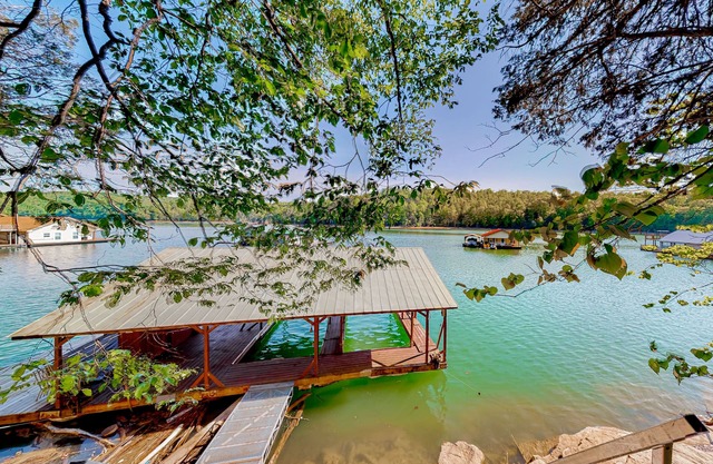 Dog-friendly waterfront home with a firepit, grill, deck, board games, & dock