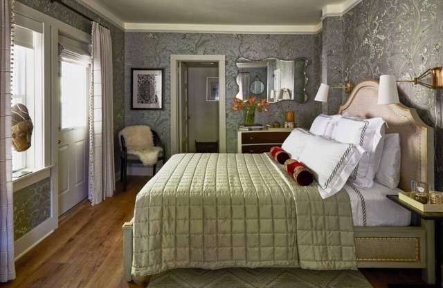 Elegant Carriage House room with a queen bed and private patio.