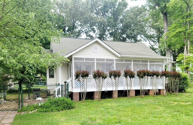 Enjoy the screened side porch, covered front porch, the quick walk to the Beach