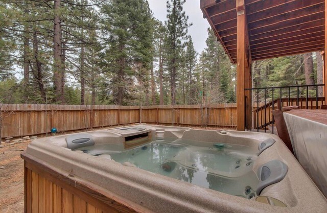 Enjoy the tree-lined yard, spacious deck, and hot tub!